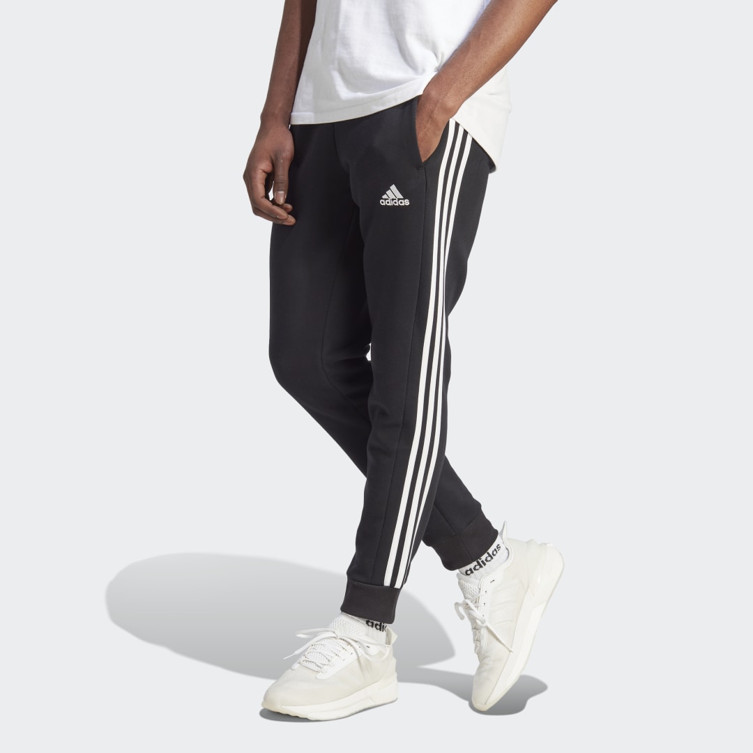 Träningsbyxor adidas Originals Essentials Fleece 3-Stripes Tapered Cuff Pants Svart | IB4030, 0
